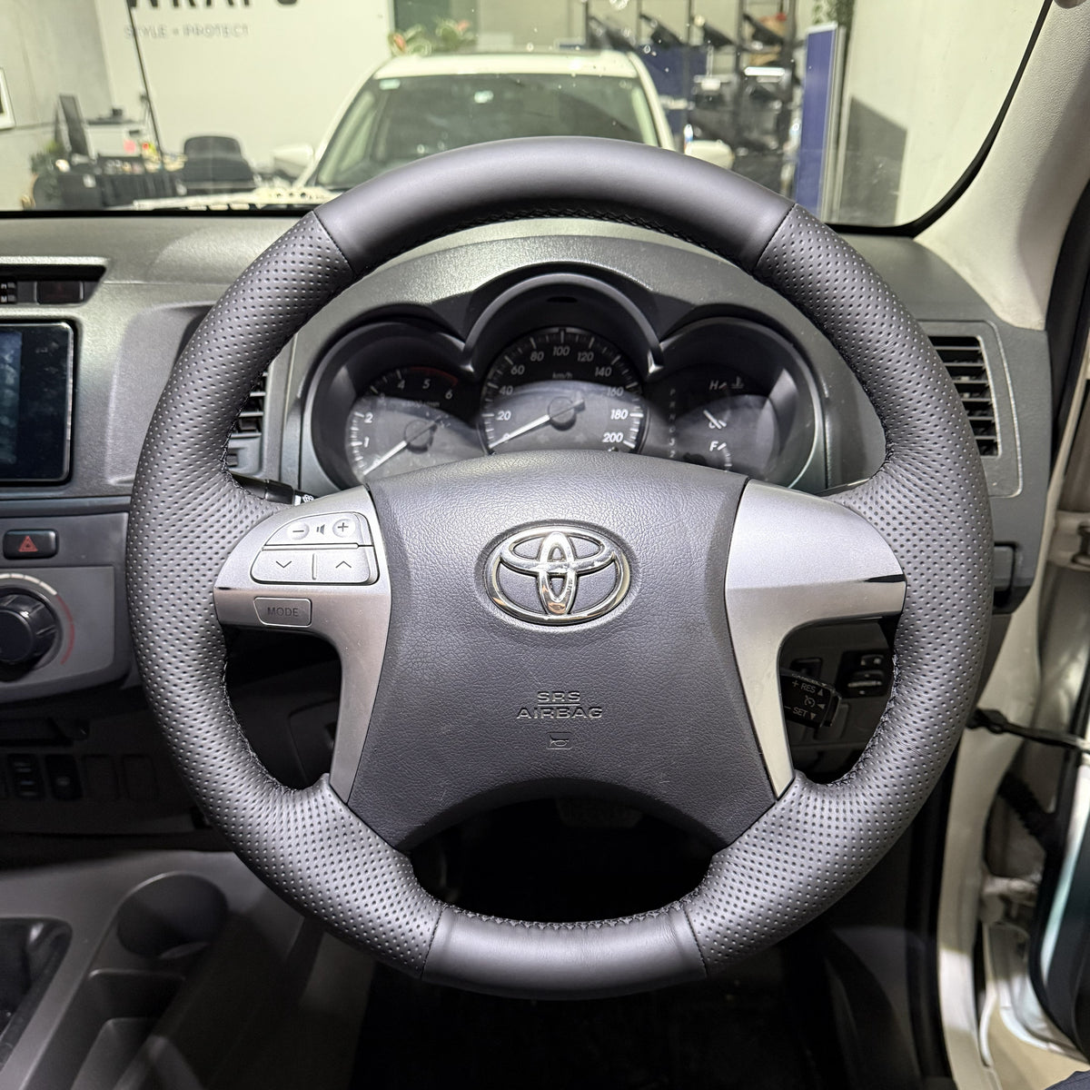 Toyota HiLux 7th Gen (2005–2015) Steering Wheel Wrap – Black Leather (smooth top, perforated sides), Black stitch